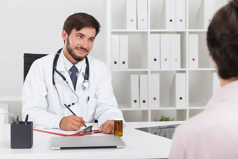 Physician smiling during a men's health visit